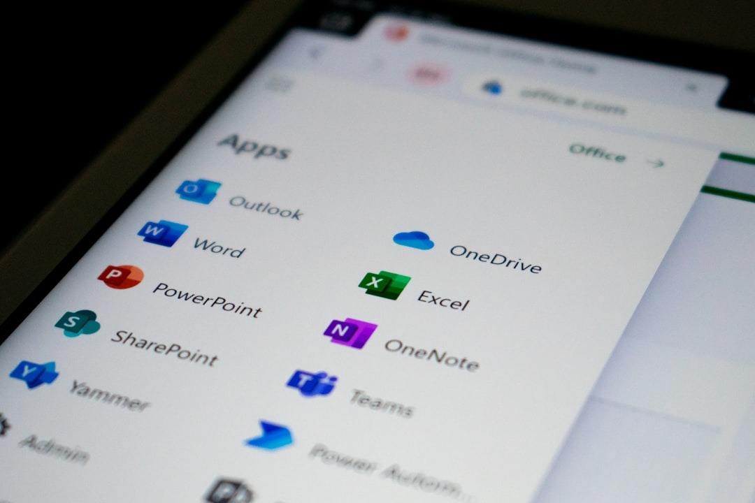 Digital screen shows Microsoft Office applications and logos.
